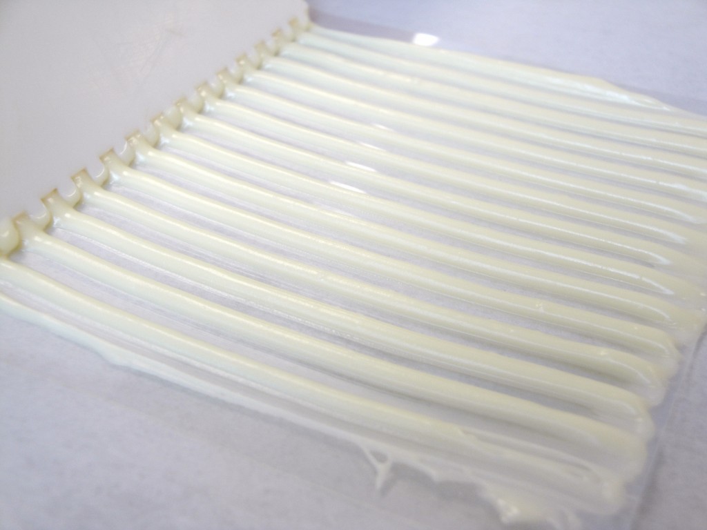 white tempered chocolate spreading on acetate 